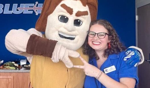 Chapter Support Coordinator, Ella Casto-Waters with university mascot.